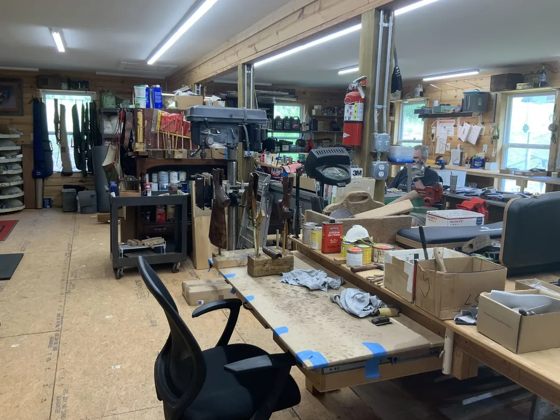 Long view down the shop, benches either side and windows at the far end